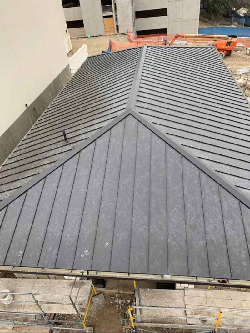 Commercial metal roof construction with crane equipment in Five Corners