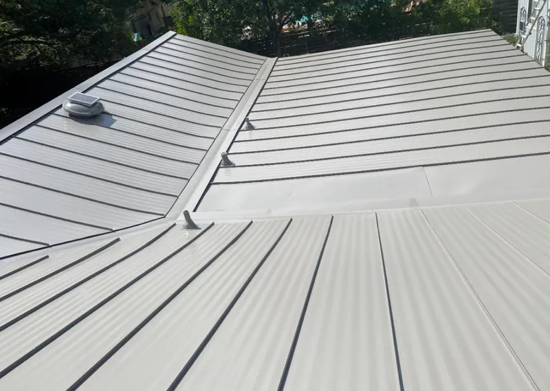 Solar attic fan installed on a metal roof for Roof Ventilation in Five Corners
